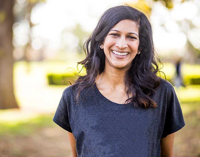 A young Indian lady smiling at the camera