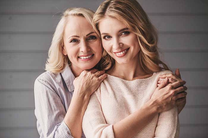 Mother and daughter smiling together