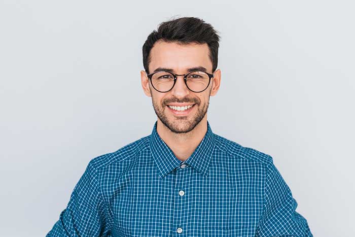 A man wearing glasses posing for a portrait