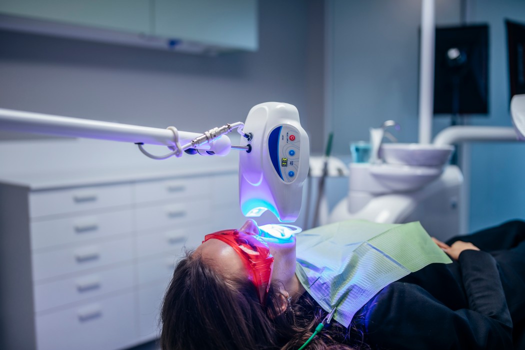 Young woman getting dental whitening treatment
